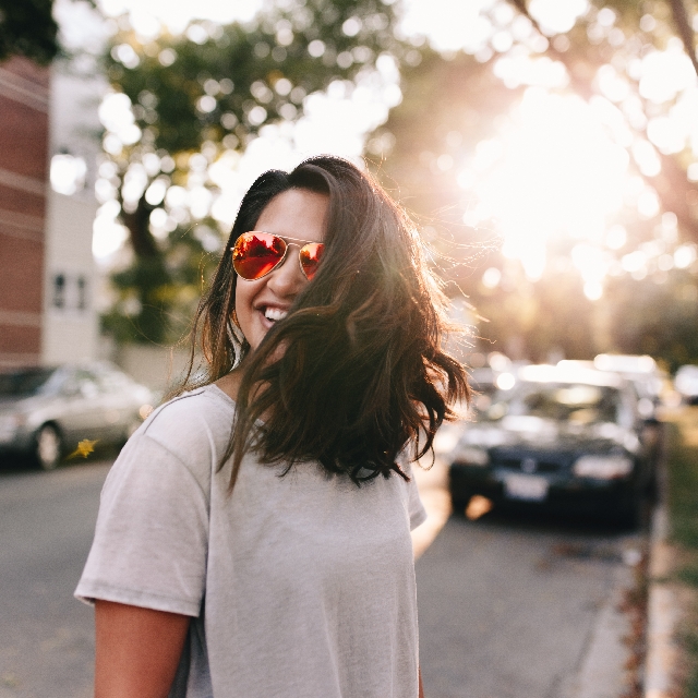 Woman with sunglasses smiling | Counseling for Depression in Houston